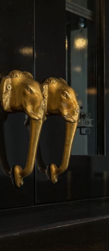 Gilded elephant head handles found in India add glitz to a kitchen cabinet.