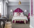 Howe adds brilliant color to the master bedroom, while echoing her client’s love for Indian textiles with a Lisa Fine fabric for headboard and bed skirt.