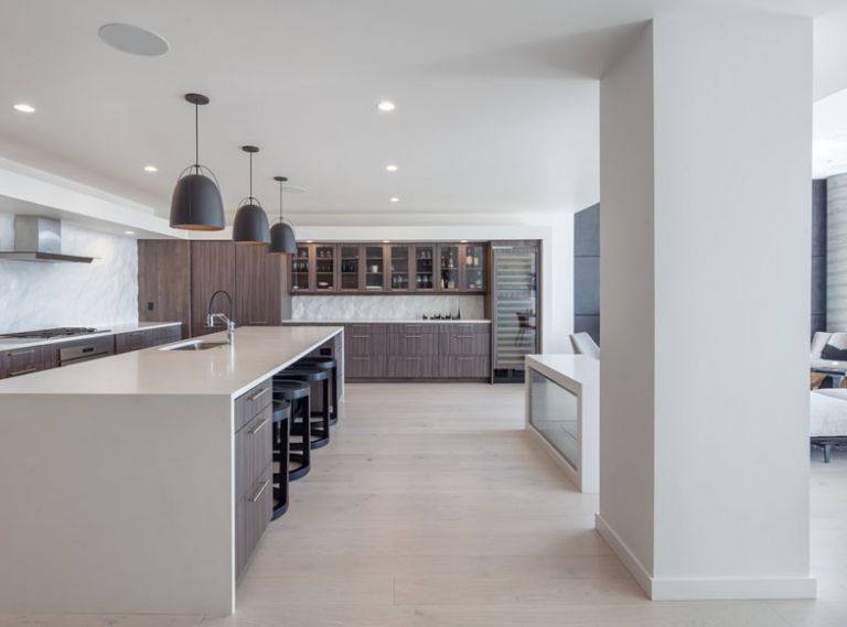 &ldquo;Anytime you are dealing with an open plan,&rdquo; says interior designer Kricken Yaker, &ldquo;it&rsquo;s tricky to design.&rdquo; She balanced the masculine elements, with textures that softened the space. Steelhead Architecture&rsquo;s L-Shape kitchen design enhances the flow.