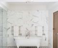 Master bath features handcrafted New Ravenna floor tiles and marble backsplash via Ann Sacks.