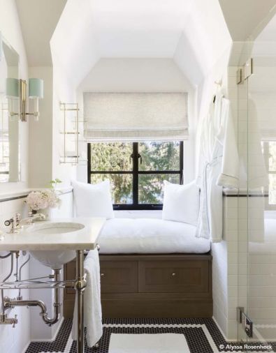 This guest bath, deemed “the most dysfunctional” by the owners, was completely gutted; Ann Sacks Waterworks tile creates a dramatic mosaic floor. A mutual love by mother and designer for terrycloth inspired the cushion fabric for the new built-in window seat with two-drawer storage. An antiquated tub/shower/toilet placement that was squeezed out into the hallway was updated and reoriented to a better location.