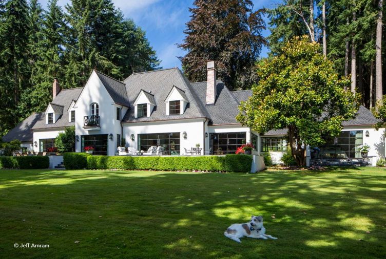 The back of the house was reoriented in 1994 to provide lush views of the water from the living areas. For the 2016 restoration, Brachvogel raised the door cassettes up a notch to prevent the friendly family dog, who greeted him each morning, from opening the doors. A crisp, hard troweled stucco Norman style exterior was also a clear mandate.