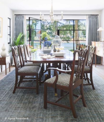 To bring the homeowners’ traditional dining room set up-to-date, Ogle reupholstered the chairs by replacing the former classic stripe with a new fabric from Fret Fabrics, a NYC luxury design house. Chandelier by Jean de Merry. Blue/green rug from Mansour Modern Strie02 adds texture and movement to the room.
