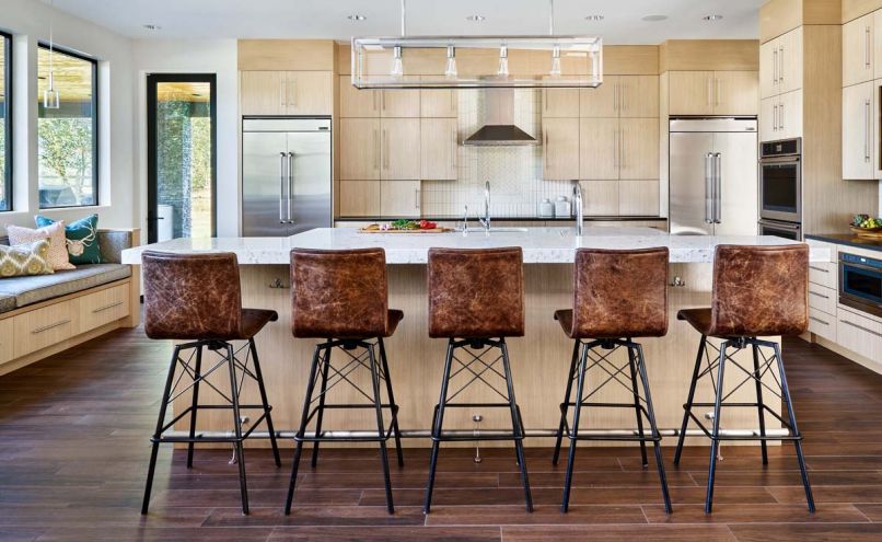 Sleek design includes no window trim or crown molding. Paint palette: Benjamin Moore Balboa Mist walls and Cloud White ceilings set against white rift oak cabinetry. Quartz countertops.