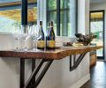 Tiffany Webber designed a floating service bar with a live walnut edge and oversized supporting brackets.