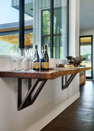 Tiffany Webber designed a floating service bar with a live walnut edge and oversized supporting brackets.