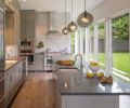 Cooking and hosting friends is a big part of these homeowners’ lives. The kitchen was designed to maximize flow and natural light to transform time spent cooking into a true pleasure. Simple lines and neutral tones give this room a calm feel, but smoked glass pendant lights add a touch of vintage flair.