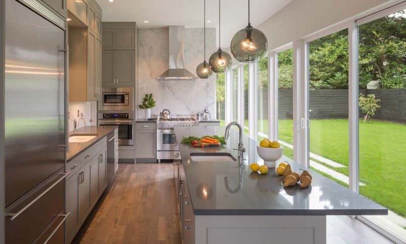 Cooking and hosting friends is a big part of these homeowners’ lives. The kitchen was designed to maximize flow and natural light to transform time spent cooking into a true pleasure. Simple lines and neutral tones give this room a calm feel, but smoked glass pendant lights add a touch of vintage flair.