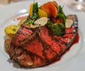 Chef Tyler Krost s grilled Snake River Farm Zabuton - American Kobe Beef Chuck topped with black summer truffles, heirloom tomato salad, and roasted potatoes.