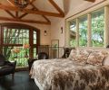 Abeja s Edison House loft-style cottage s master bedroom sits up half a story, where the branches of the trees feel within reach.