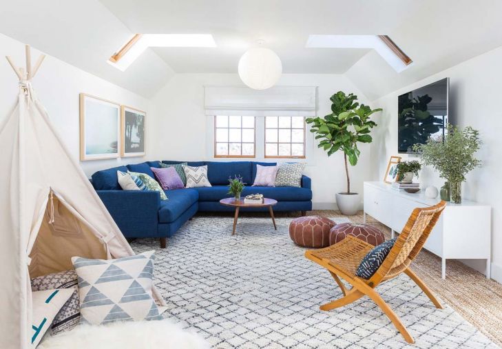 An upstairs den was transformed from a dark nook to a light, bright space that serves double-duty as a kid’s playroom during the day and an adult retreat in the evening. “During the day we can have it messy and crazy with toys, and then it’s really easy to clean up,” says the homeowner. “Then at night, we’ll sit up there, light a candle, and watch TV, and it feels like a totally adult space.”