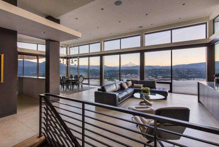 A horizontal cloud was added as an architectural feature to counteract the tall vaults at the main living area/entry, where a bridge connects the upper guest parking area with the living room, and the spectacular view of Mt. Hood beyond.