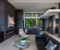 Staircase from the lower level and attached garage faces the kitchen, carrying through the same Raven Caesarstone ledge at left as is found on the kitchen island countertop ahead.