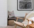 Chairs by France and Son, a vintage Moroccan rug, and wood touches create an elegant warmth in the living room.