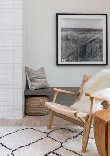 Chairs by France and Son, a vintage Moroccan rug, and wood touches create an elegant warmth in the living room.