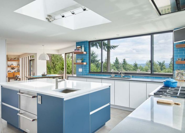 Floating walnut shelves made by Schoener, cabinets by Brookhaven. Blanco plumbing fixtures from Master Source and Abbrio. Miele cooktop and Liebherr refrigerator add industrial touches. Five Star Granite installed the countertops which came from Pental. Statements Tile flooring.