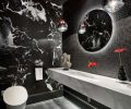 Topographic black wall-paper adds movement to the red-dominated powder room.