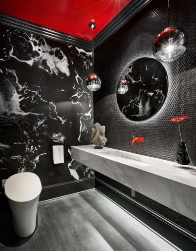 Topographic black wall-paper adds movement to the red-dominated powder room.