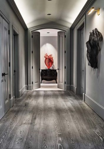 By unifying the hallway finishes that included wood and painted surfaces with a single gray paint, Boyer’s red steel mesh artwork becomes center stage.