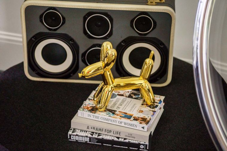 Jeff Koons gold balloon dog prances before Ezra Cimino-Hurt black and white Case of Bass boombox.