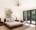 Expansive Pella windows and french doors in the master bedroom open up to the lush green forested surroundings West Portland is famous for.