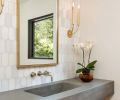 Powder room countertops with integrated sink, and white marble background. Cement custom made by Cement Elegance.