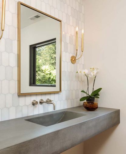 Powder room countertops with integrated sink, and white marble background. Cement custom made by Cement Elegance.