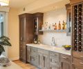 Oak Grove Cabinets pop against a Porcelanosa Lines Mini Strip Grey tile backsplash.