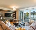 A Bedford Brown sectional and black lacquered wood coffee table add to the room’s coziness.