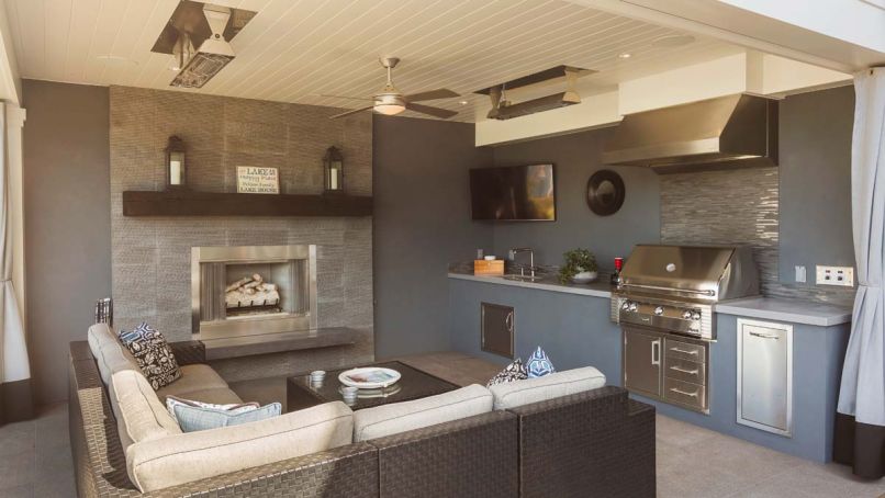 The outdoor room includes heat lamps for coziness, and porcelain tile floor. Fireplace face from Stone Source Inca Gray chiseled echoes BBQ backsplash of Pental bluestone Natural split plus mosaic. A smaller BBQ area located on deck off kitchen for dinners for two.