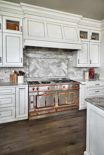 Provenza flooring, an engineered prefinished European oak stands up to heavy traffic, while a top-of-the-line La Cornue range from Eastbank Conractor Applinaces, makes cooking a visual and task-oriented delight. Herringbone marble backsplash.