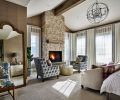 Concord Stone Veneer fireplace pairs with Skyline Windows elegant automated draperies and diamond tufted chairs and a fainting sofa.