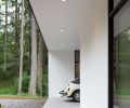 Outside, looking towards the carport, wide eaves create shelter from the rain while minimizing glare inside the home.