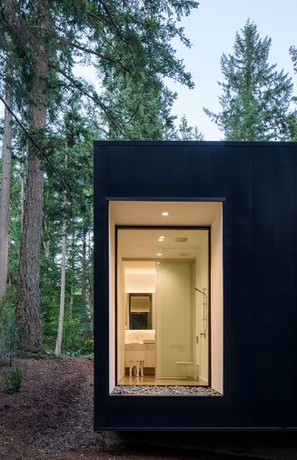 The master bathroom, viewed from the exterior. A gravel bed outside the window uses river rock similar in color to the interior concrete floor to underscore the inside-outside connection. “It just extends your eye to the exterior,” says Joseph.