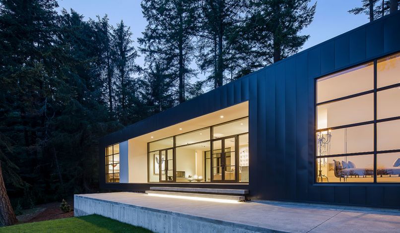 The simple, rectangular shape of the home is clad in metal siding for a clean, unadorned look.