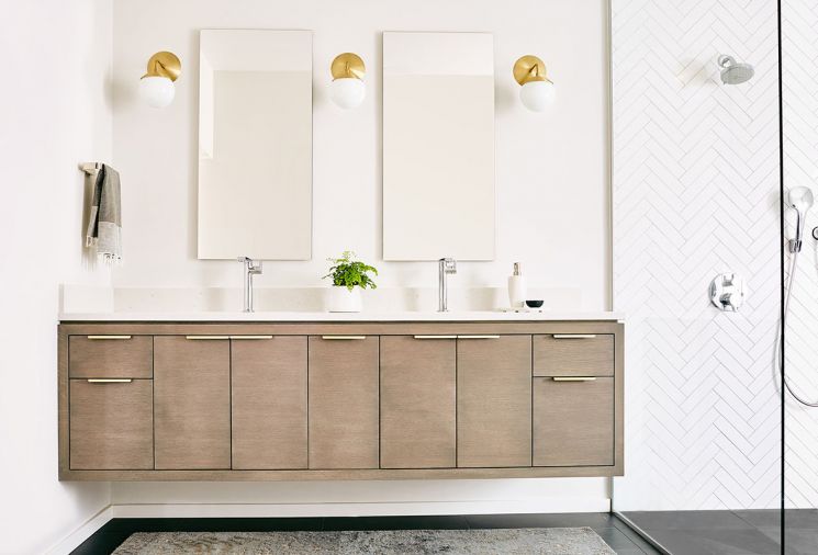 An open, spacious master bathroom layout brings serenity to the morning routine. “These homeowners wanted a very open room, which was in part a reaction to the former bathroom they were using, which had a tiny, compartmentalized shower,” says Jenny. The custom floating vanity was manufactured locally.