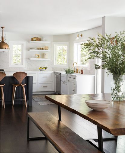 A custom live-edge walnut dining room table is paired with benches for a streamlined look. “You can slide the bench under the table and it just disappears,” explains Heidi. “Chairs can sometimes feel like they’re in the way.”