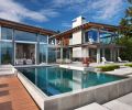 Exposed beams inside and out team with concrete chimney and fireplaces. Poured concrete exterior forms for the stairs, pool and koi pond by GCW.