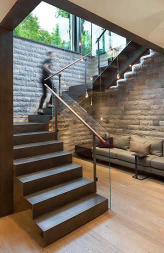 The modest amount of space dedicated to the stair well could have felt hemmed in and claustrophobic with an enclosed staircase, so Garret designed an open-tread stair system to keep the space feeling light and airy. Narrow windows on the landing offer peekaboo views.