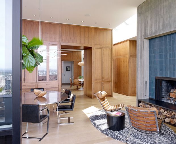 Each black walnut veneer was hand picked by the architects, homeowner and builder at Mark Newman Design in Wood. A custom Paul Rudolph Modulightor light fixture floats above the oval Pergay dining table to avoid obstructing view or architecture. Vintage 1960s Arne Norell chairs and Robert Kuo lacquer drumstool cozy up to the concrete and tile fireplace.
Photography © Jeremy Bittermann