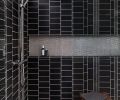 In the master bath shower, one of the homeowners used her graphic design skills to create a custom tile layout using simple charcoal glaze ceramic tile. “I wanted something that wasn’t overly symmetrical and that had a good sense of movement to it,” says the homeowner. “It’s fun that I was able to put my stamp on something.”