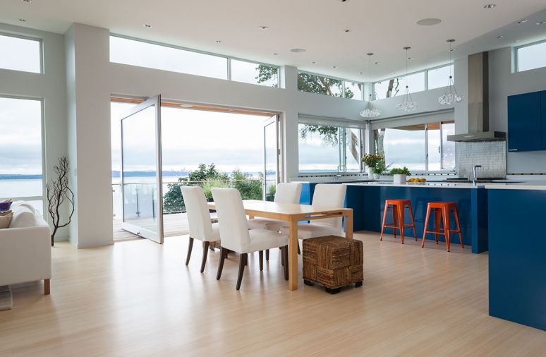 Three pendant lights featuring clustered halogen bulbs provide a sculptural touch to the kitchen without taking attention away from the saturated blue cabinetry. “They’re elegant and interesting, but not show stealers,” explains Rausch.