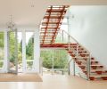 A floating steel staircase provides access to the home office and rooftop deck in the home’s “tower.”