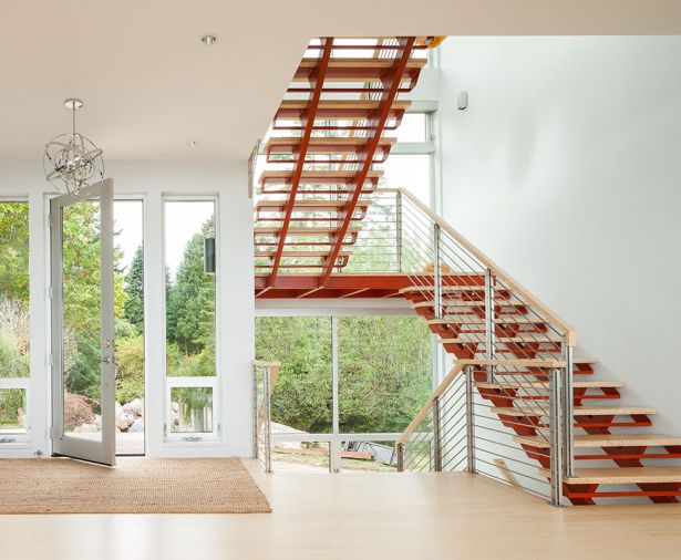 A floating steel staircase provides access to the home office and rooftop deck in the home’s “tower.”
