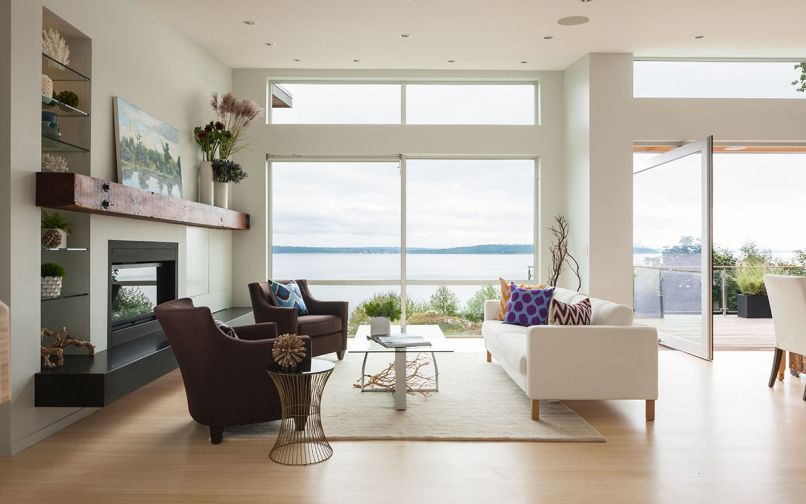 In the living room, the honed absolute black granite hearth is cantilevered to give it a floating feel.