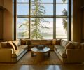 Hunziker’s U-shaped Coraggio mohair sofa nestles before stately Fleetwood windows facing lake on Lapchi rug.