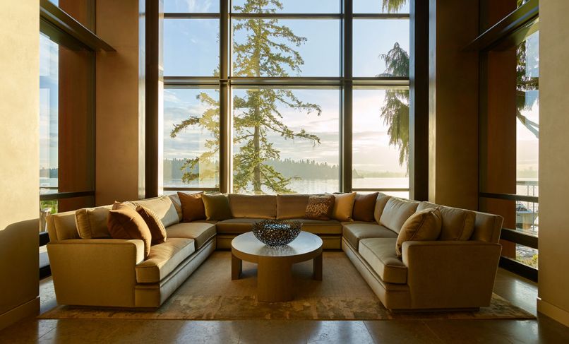 Hunziker’s U-shaped Coraggio mohair sofa nestles before stately Fleetwood windows facing lake on Lapchi rug.