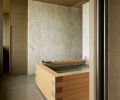 Hunziker custom closet door with metal pull echoes wooden Japanese soaking tub.