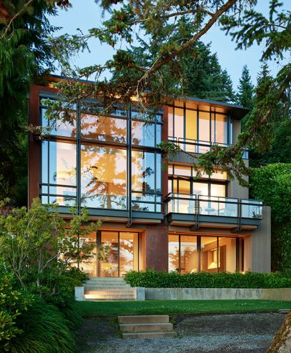 Baba changed entire face of the former home to open toward views. Obscured by tree limb left is master bathroom with green planted roof.