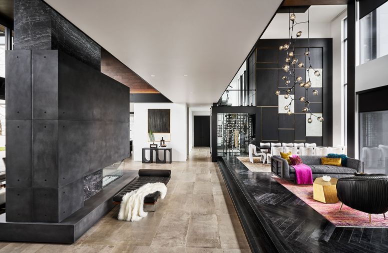 Color-impregnated curly maple herringbone entry flooring by Provenza Floors. Kush Rugs; Kelly Wearstler black Souffle chairs; Barcelona Couch from Design Within Reach.